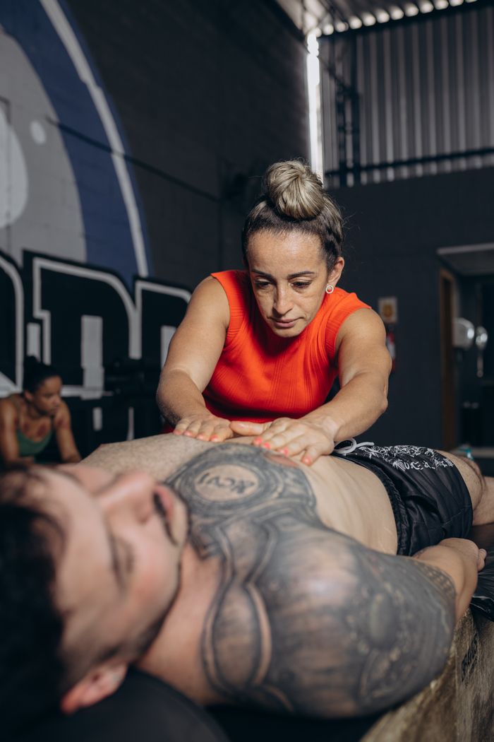 A sports therapist performing massage therapy for muscle recovery and rehabilitation.